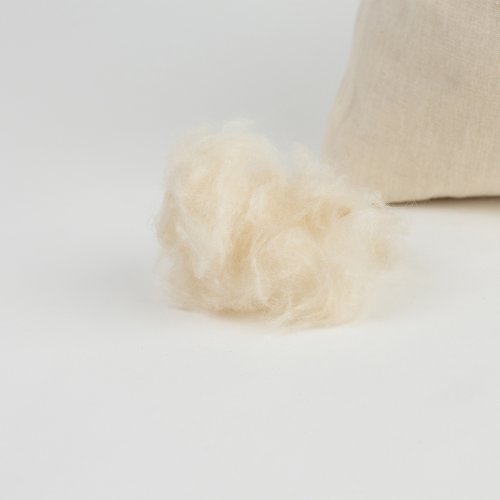 Loose kapok fibres beside a fabric bag